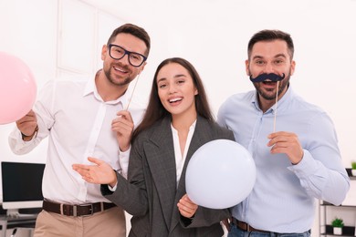 Photo of Coworkers having fun during office party indoors