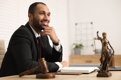 Photo of Portrait of smiling lawyer at table in office