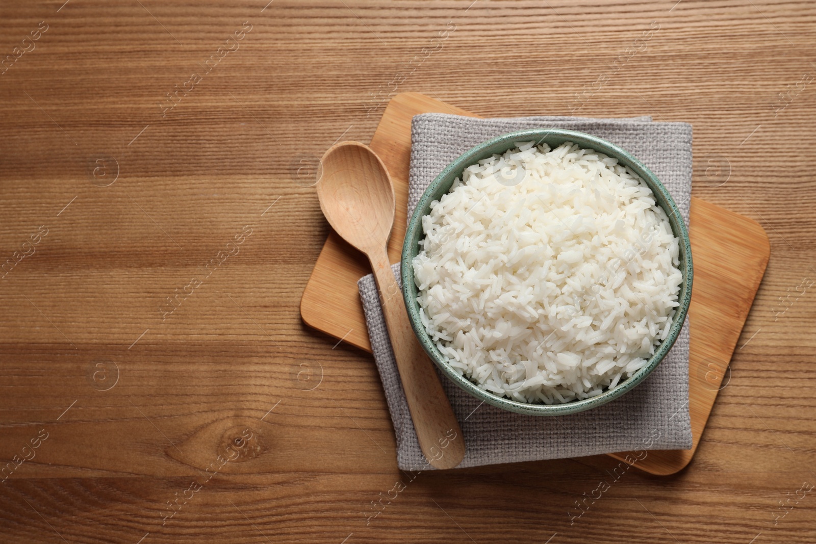 Photo of Bowl of tasty cooked rice served on table, flat lay. Space for text