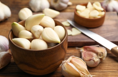 Photo of Fresh organic garlic on wooden table, closeup