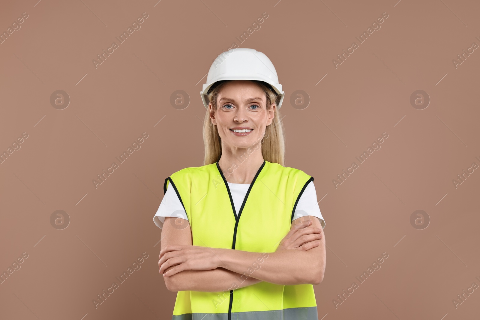 Photo of Engineer in hard hat on brown background