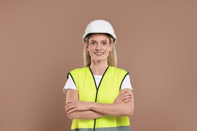 Photo of Engineer in hard hat on brown background