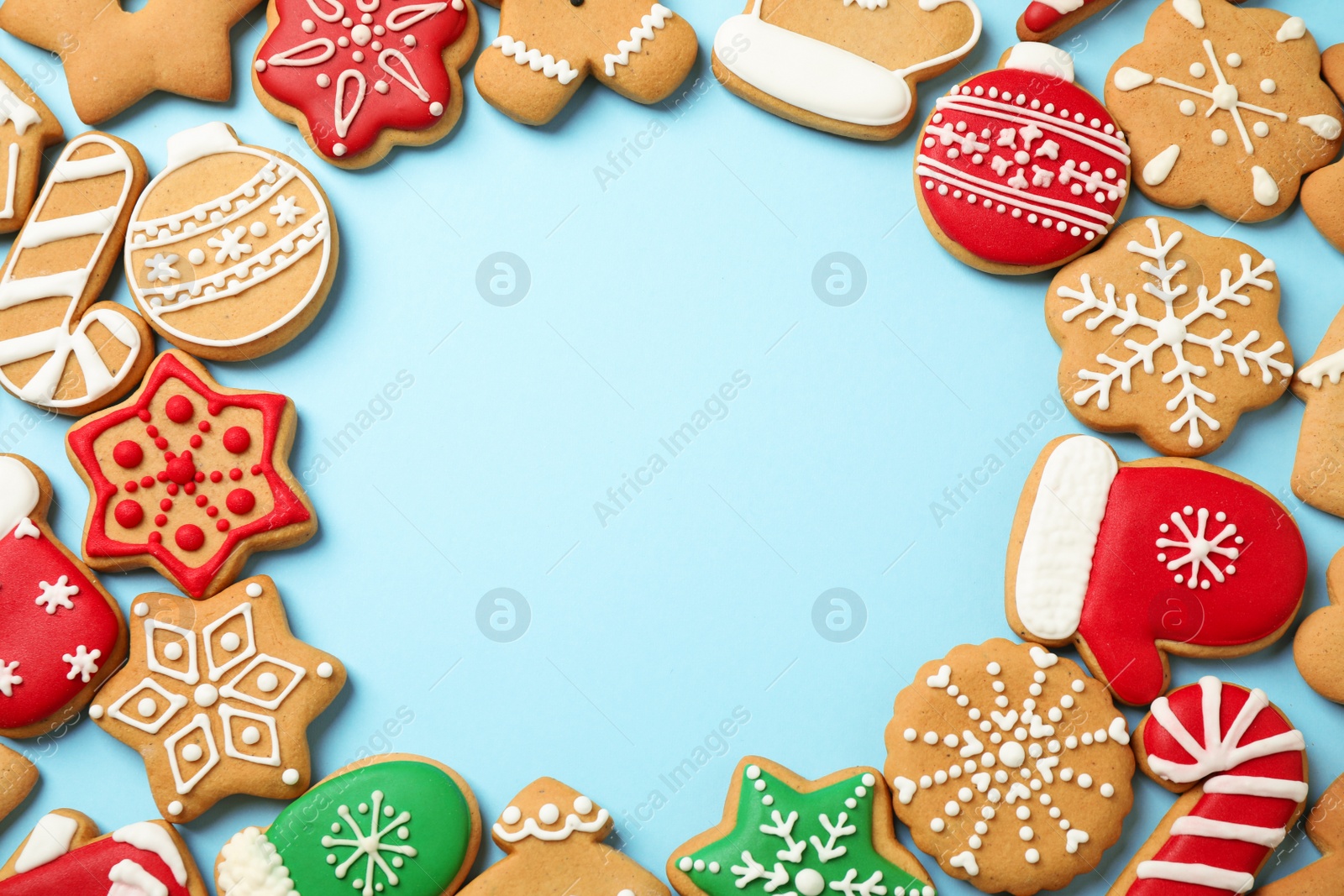 Photo of Flat lay composition with tasty homemade Christmas cookies on light blue background, space for text