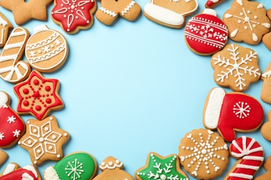 Photo of Flat lay composition with tasty homemade Christmas cookies on light blue background, space for text