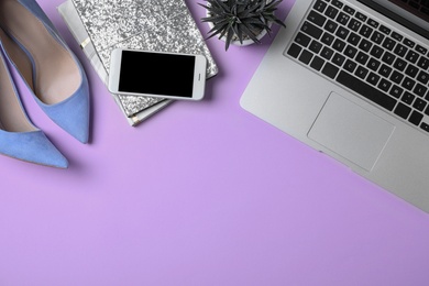 Photo of Flat lay composition with laptop and fashion blogger's stuff on lilac background, space for text