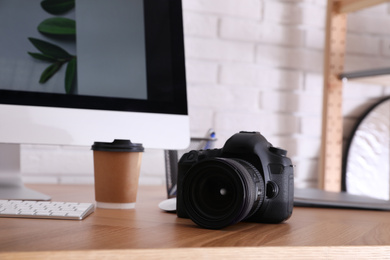 Photo of Photographer's workplace with professional camera in office