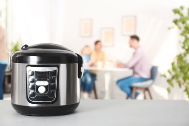 Modern multi cooker on table in kitchen
