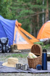 Image of Thermos and other camping equipment outdoors on summer day 
