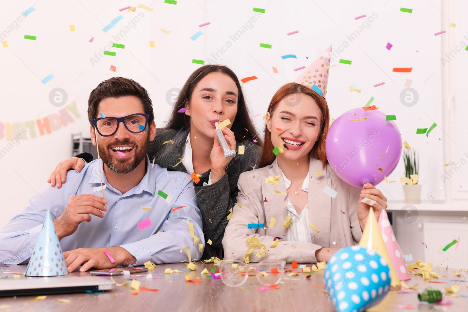 Photo of Coworkers having fun during office party indoors