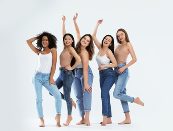 Group of women with different body types on light background