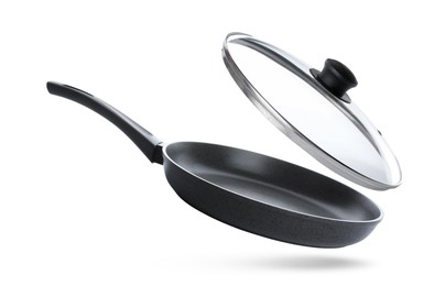 Image of New frying pan and glass lid on white background