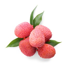 Pile of fresh ripe lychees with green leaves on white background, top view