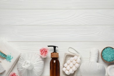 Photo of Flat lay composition of herbal bags and spa products on white wooden table, space for text