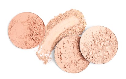 Photo of Different face powders and swatch on white background, top view