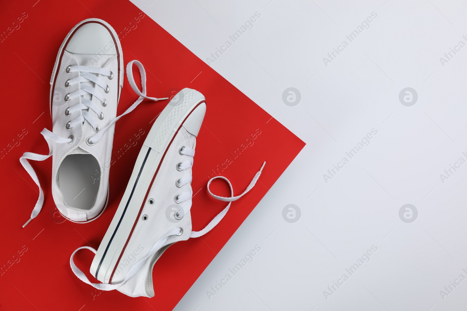 Photo of Stylish sneakers on color background, flat lay. Space for text