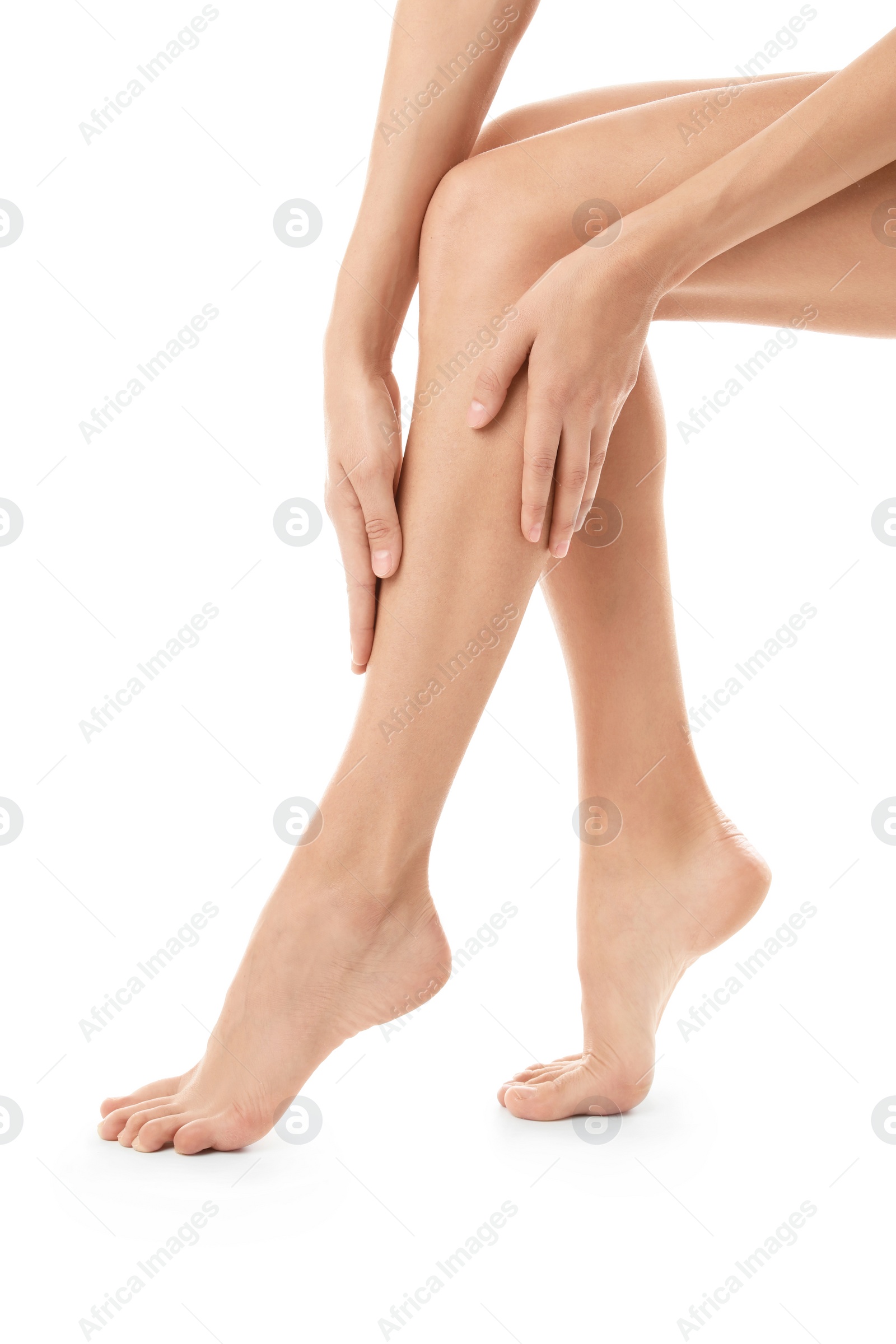 Photo of Young woman with beautiful long legs on white background, closeup