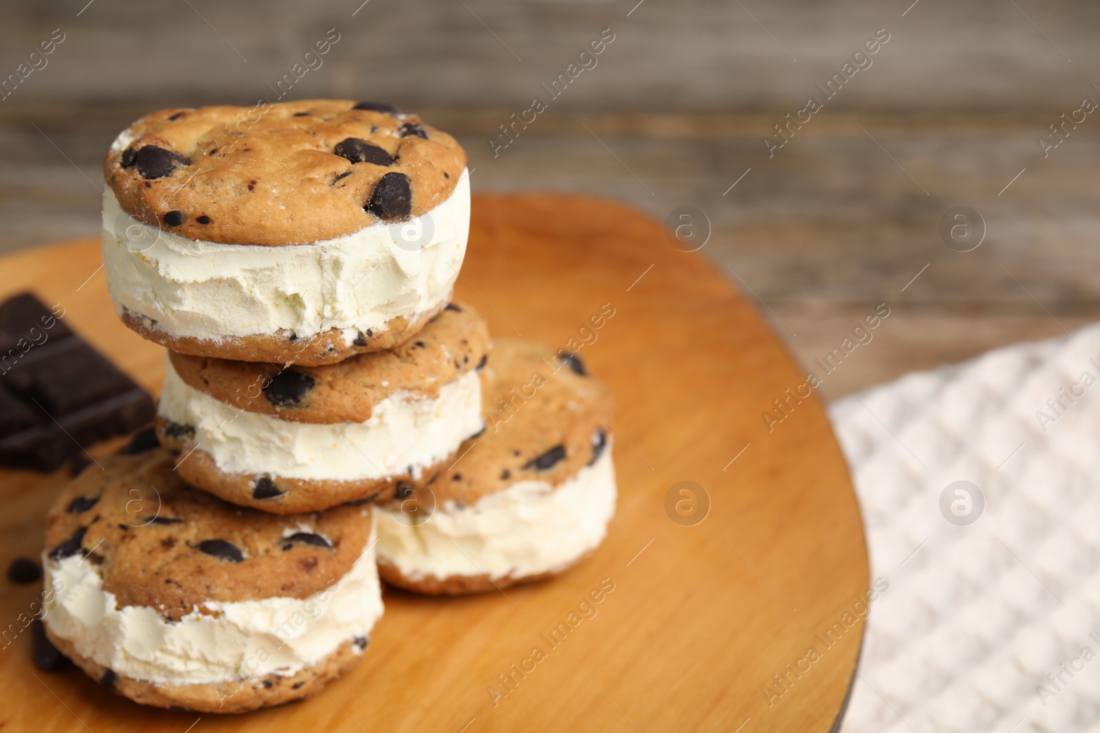 Photo of Sweet delicious ice cream cookie sandwiches on table, space for text