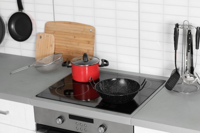 Photo of Clean cookware and utensils in modern  kitchen