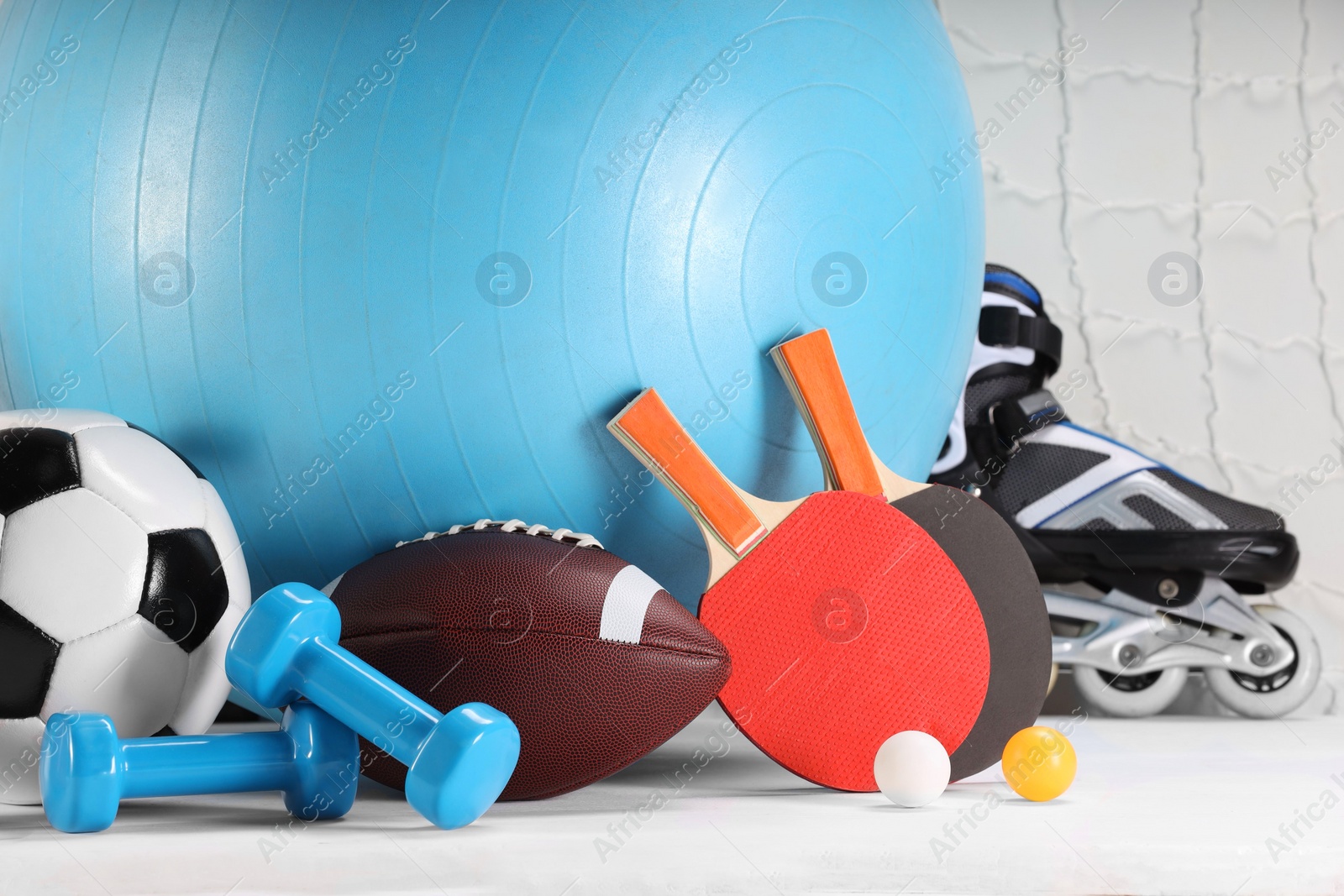 Photo of Many different sports equipment on white table