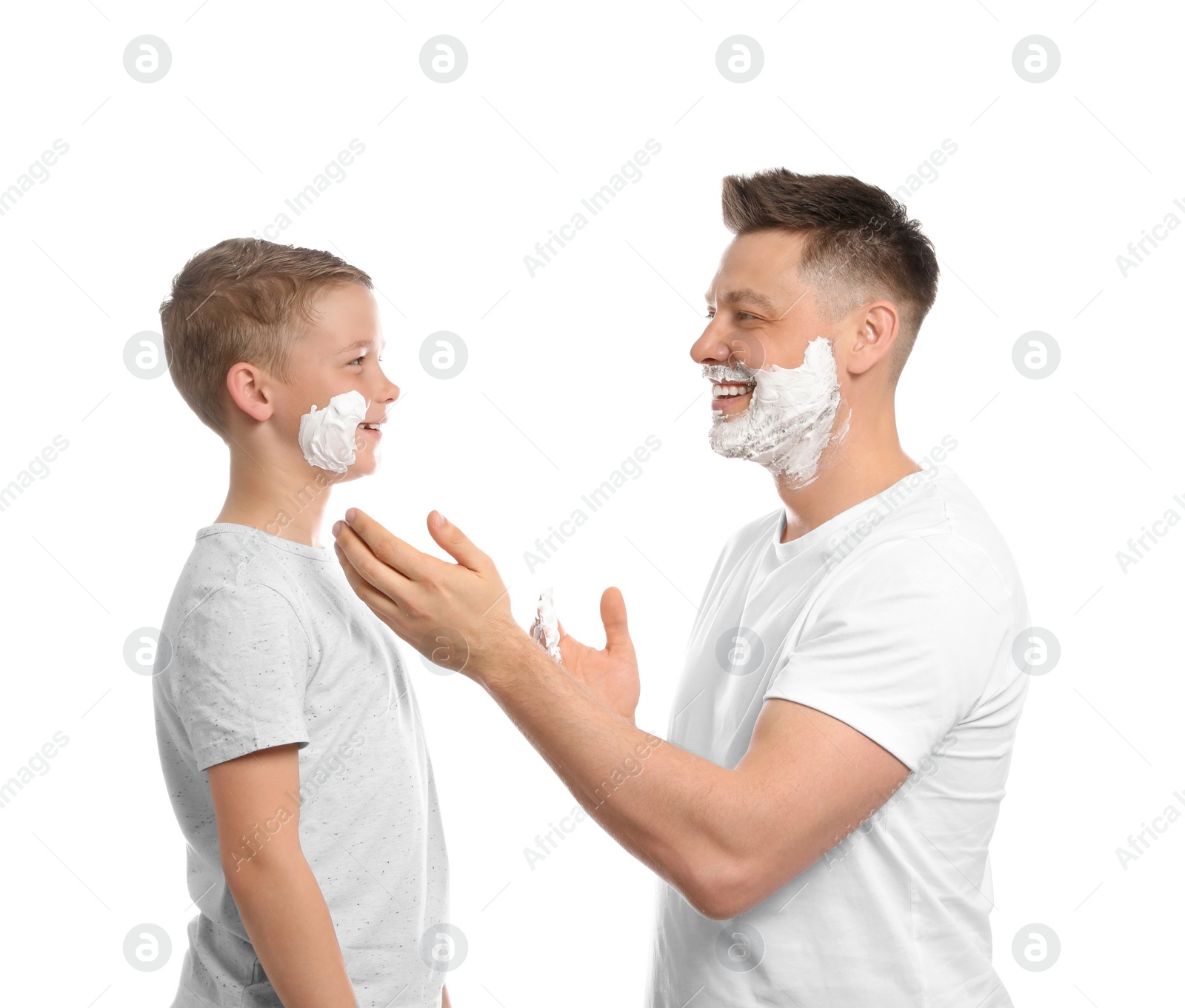 Photo of Dad applying shaving foam on son's face, white background