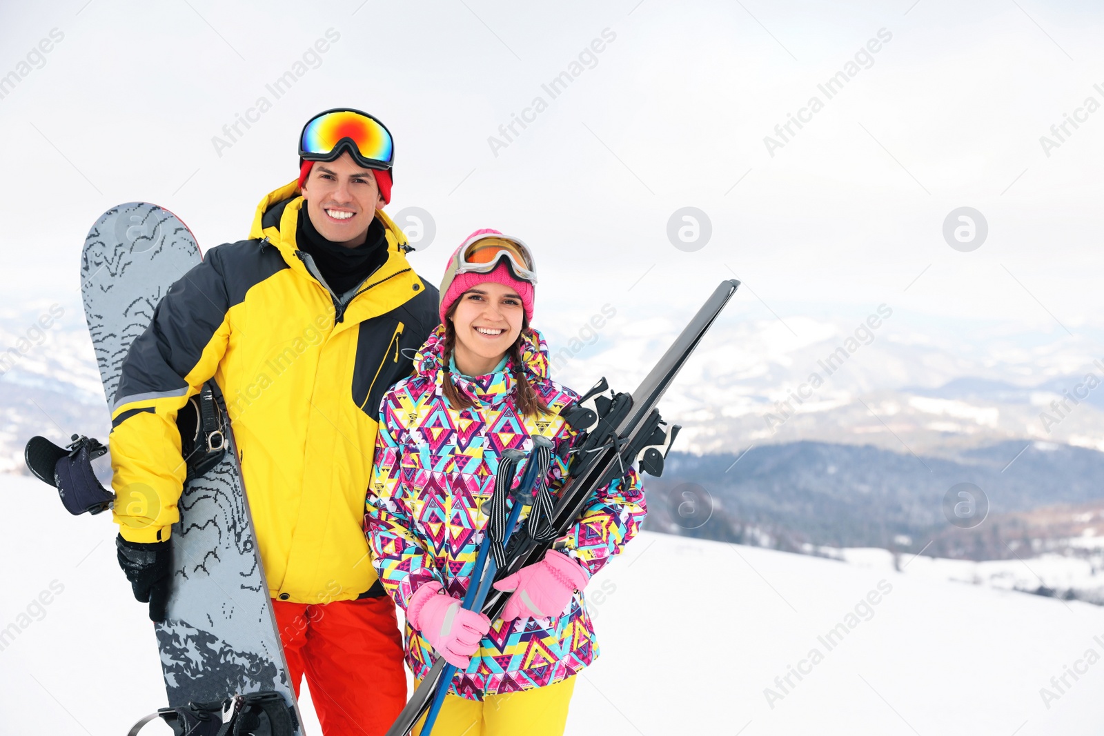 Photo of Lovely couple with equipment at ski resort. Winter vacation