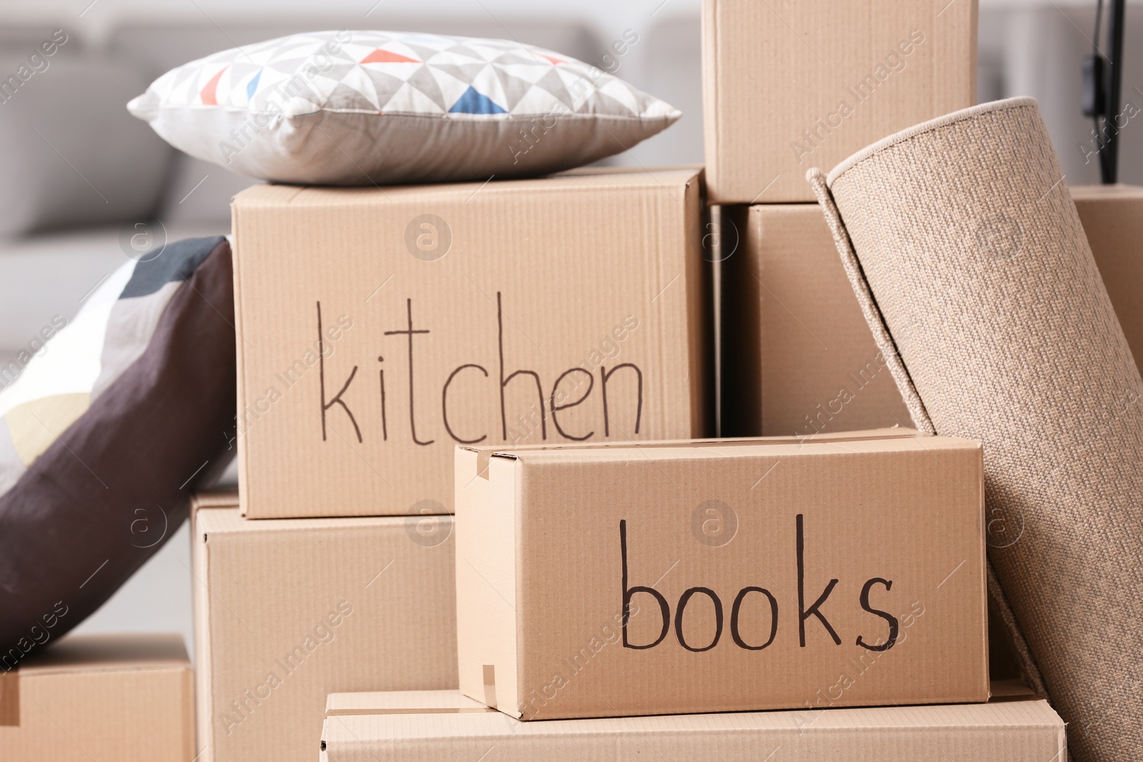 Photo of Cardboard boxes and household stuff, closeup. Moving day