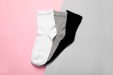 Different socks on color background, flat lay