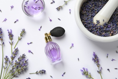 Photo of Composition with natural perfume and lavender flowers on white background, top view. Cosmetic product