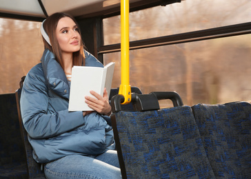 Woman listening to audiobook in trolley bus