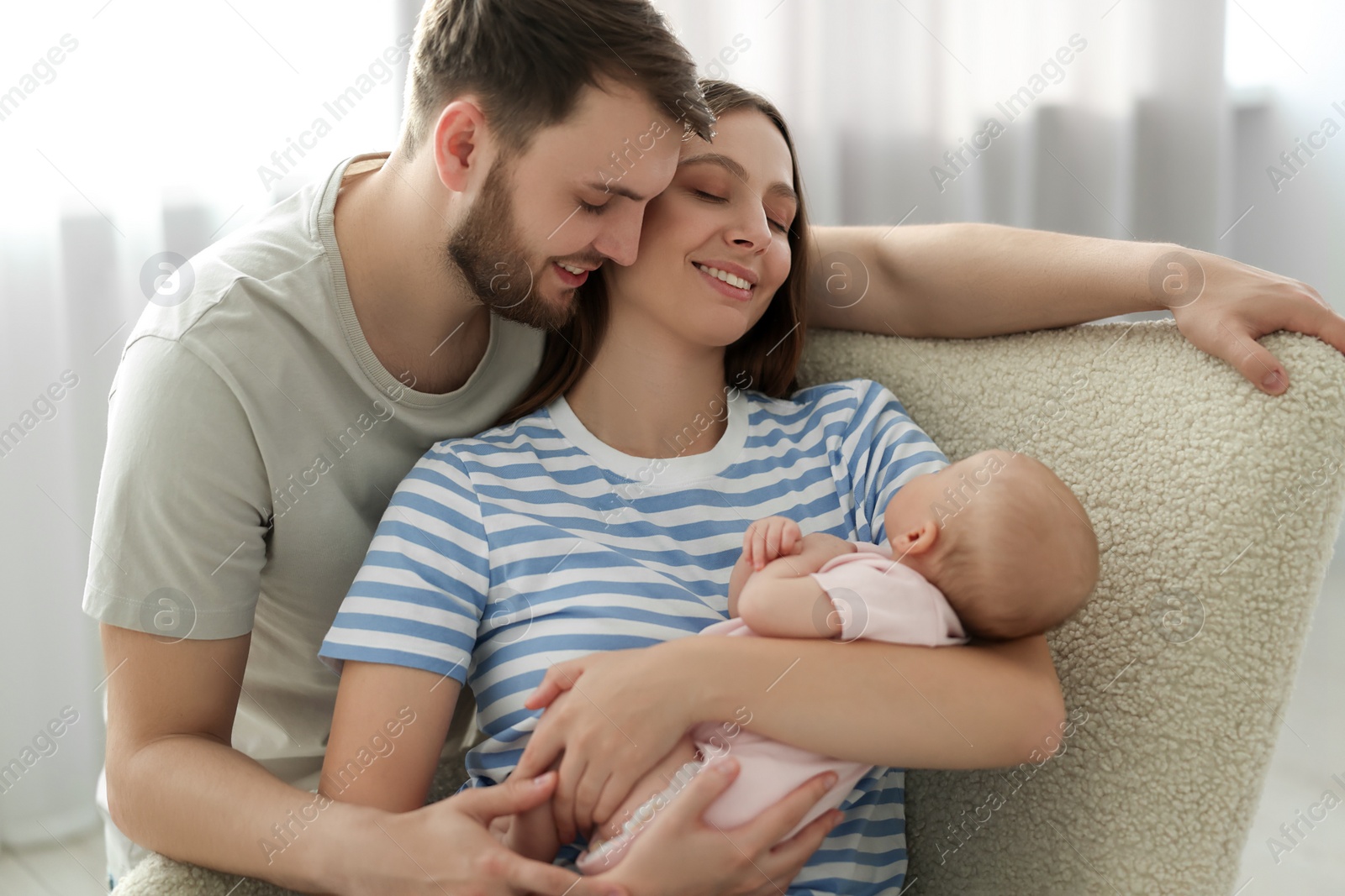 Photo of Happy family. Parents with their cute baby at home