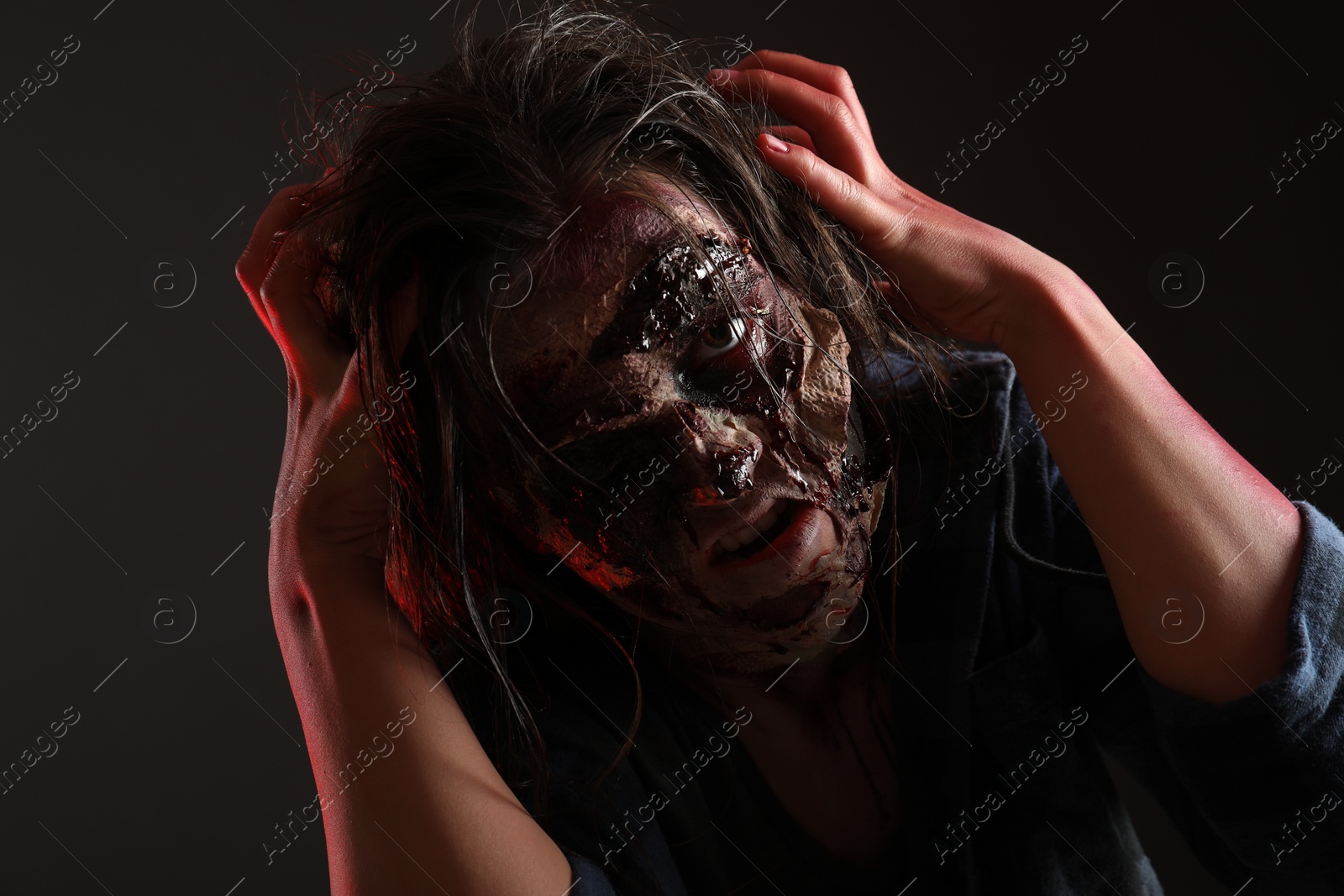 Photo of Scary zombie on dark background. Halloween monster