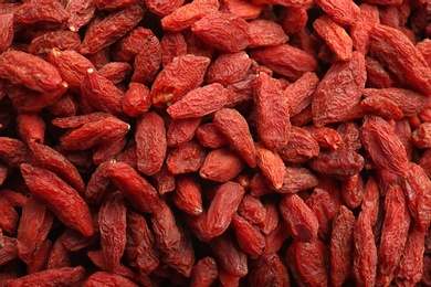 Photo of Many dried goji berries as background, closeup. Healthy superfood