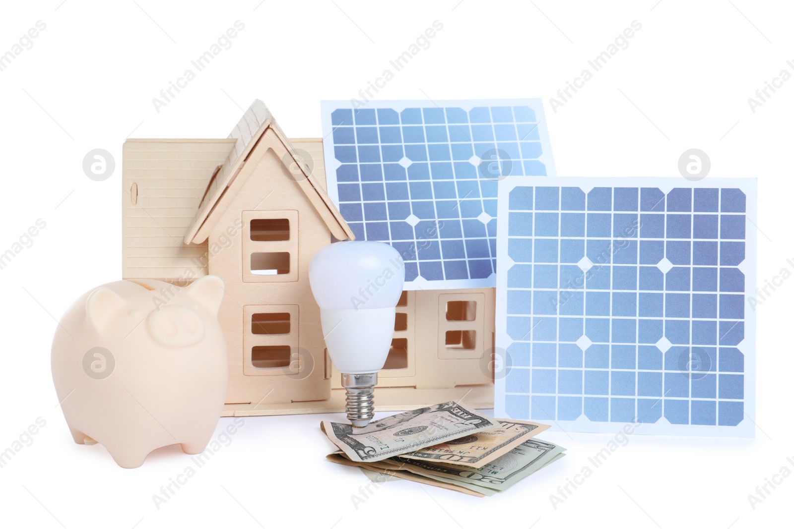 Photo of Composition with solar panels and wooden house model on white background