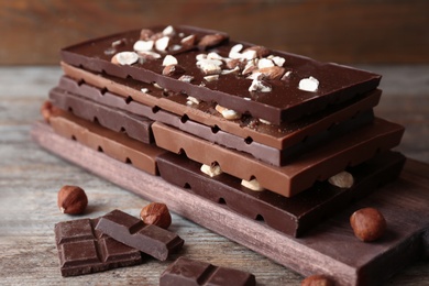 Different delicious milk and dark chocolate bars on table