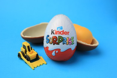 Sveti Vlas, Bulgaria - June 29, 2023: Kinder Surprise Eggs, plastic capsule and toy on light blue background
