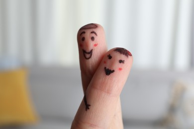 Photo of Two fingers with drawings of happy faces on blurred background. Spending time together