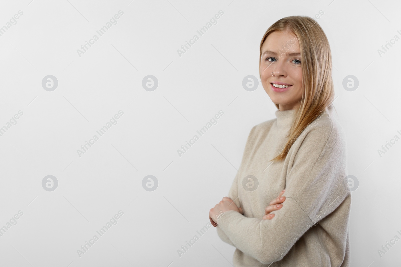 Photo of Portrait of beautiful young woman in stylish sweater on white background. Space for text