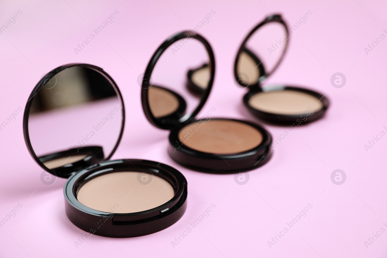 Photo of Face powders on pink background, space for text
