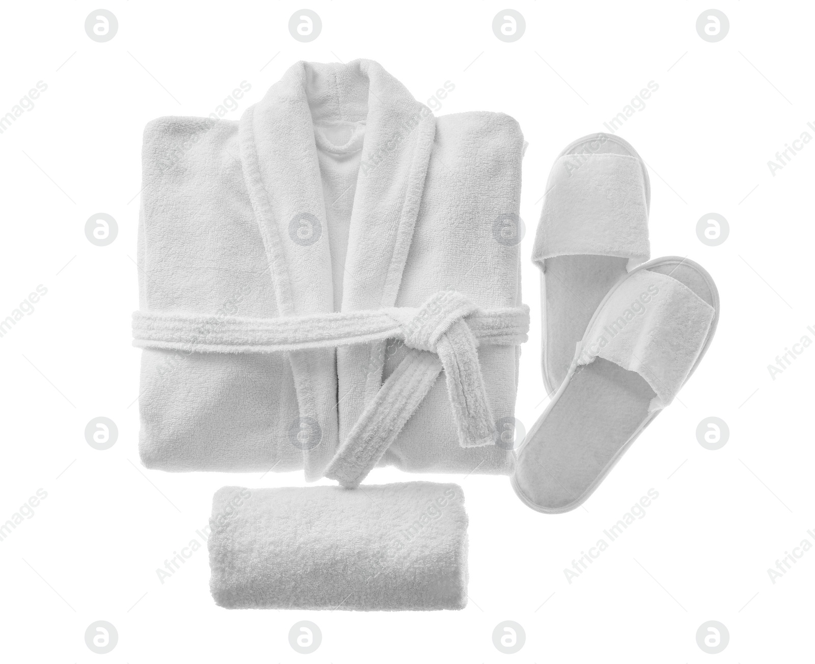 Photo of Clean folded bathrobe, slippers and towel isolated on white, top view