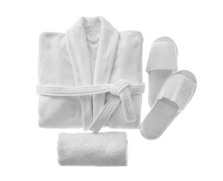 Photo of Clean folded bathrobe, slippers and towel isolated on white, top view