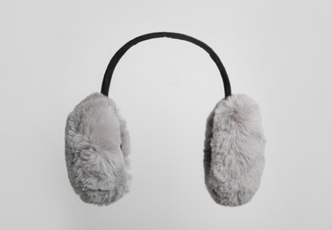 Fluffy earmuffs on white background. Stylish winter accessory