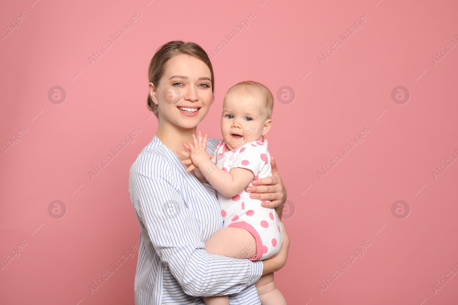 Photo of Portrait of happy mother with her baby on color background