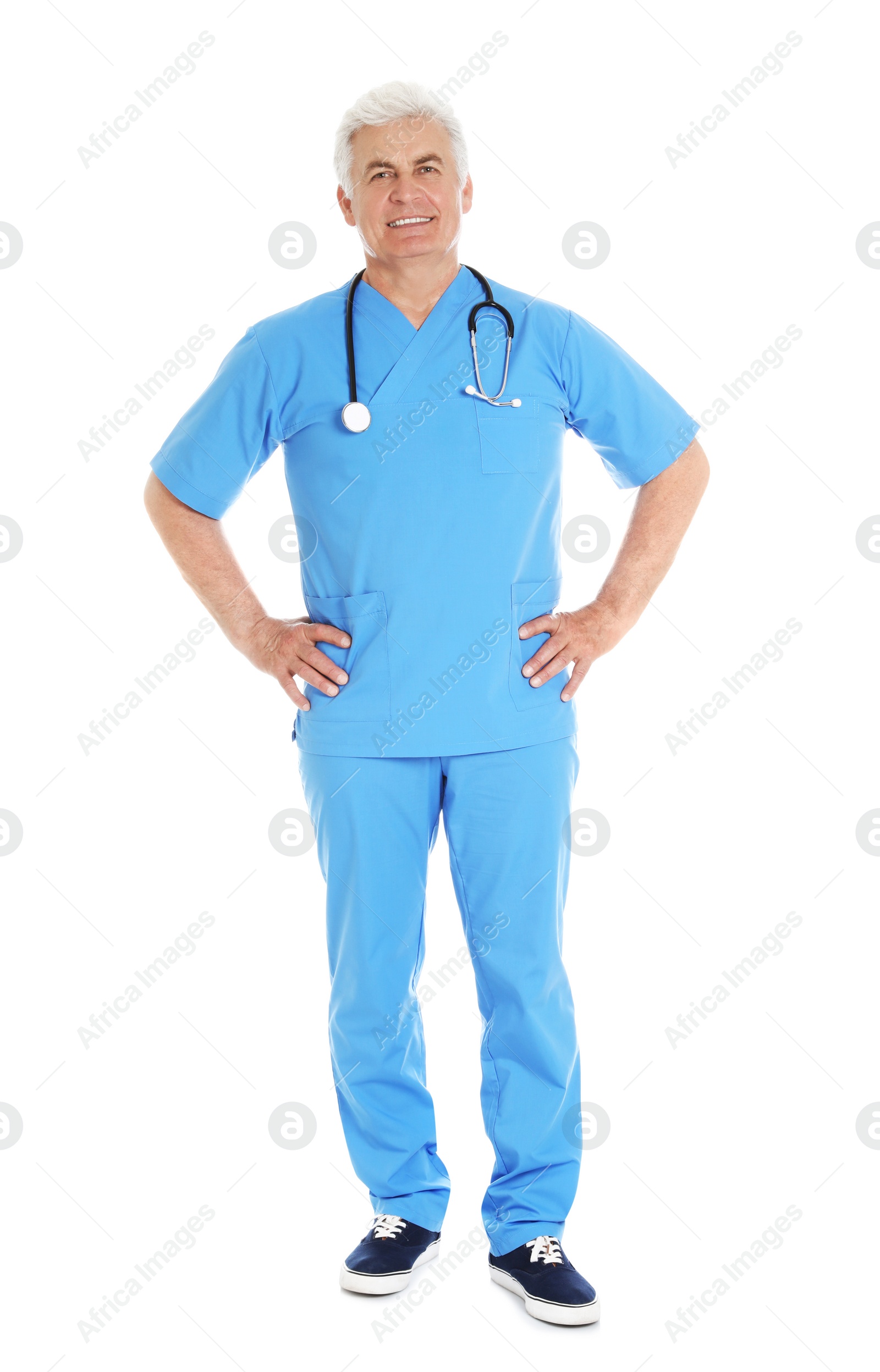 Photo of Full length portrait of male doctor in scrubs with stethoscope isolated on white. Medical staff