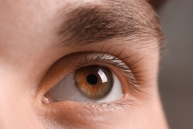 Photo of Man with beautiful eyes on blurred background, closeup