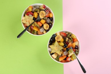 Photo of Delicious exotic fruit salad on color background, flat lay