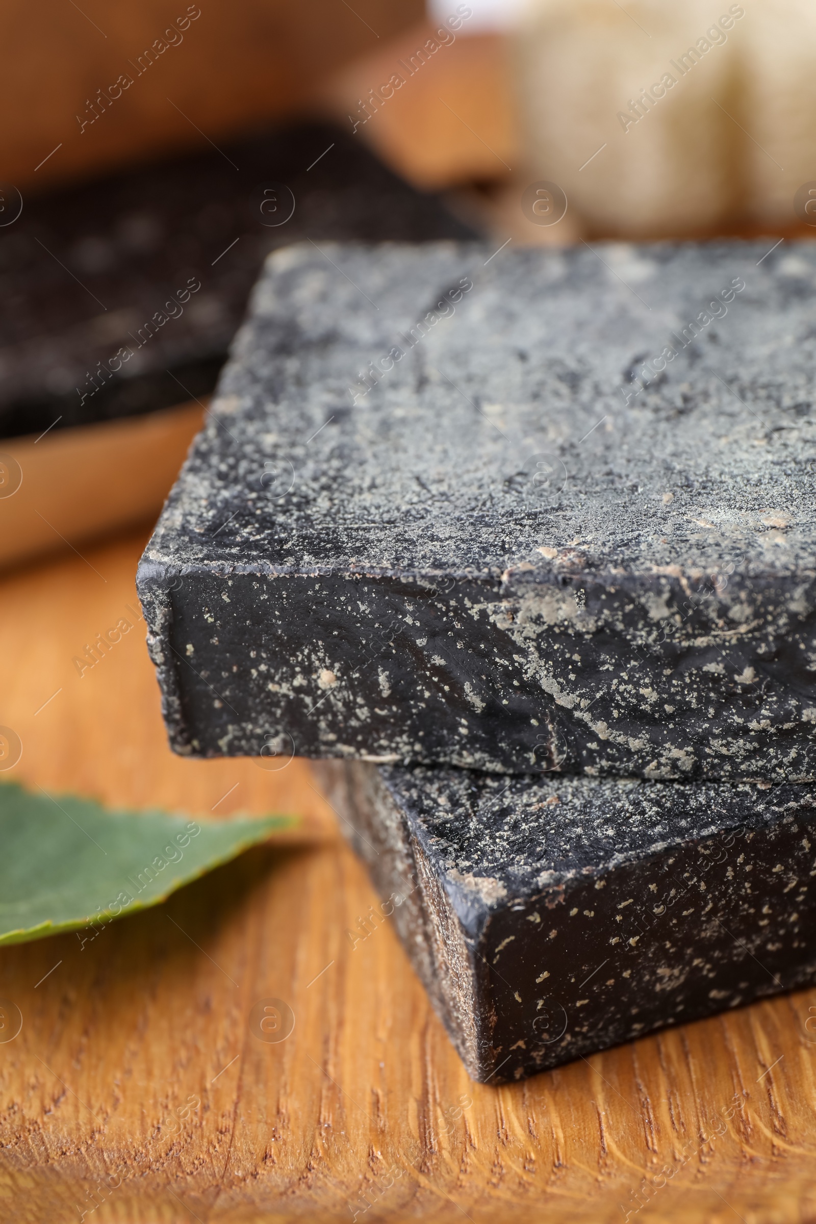 Photo of Tar soap on wooden table, closeup. Natural product