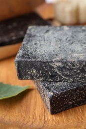 Tar soap on wooden table, closeup. Natural product