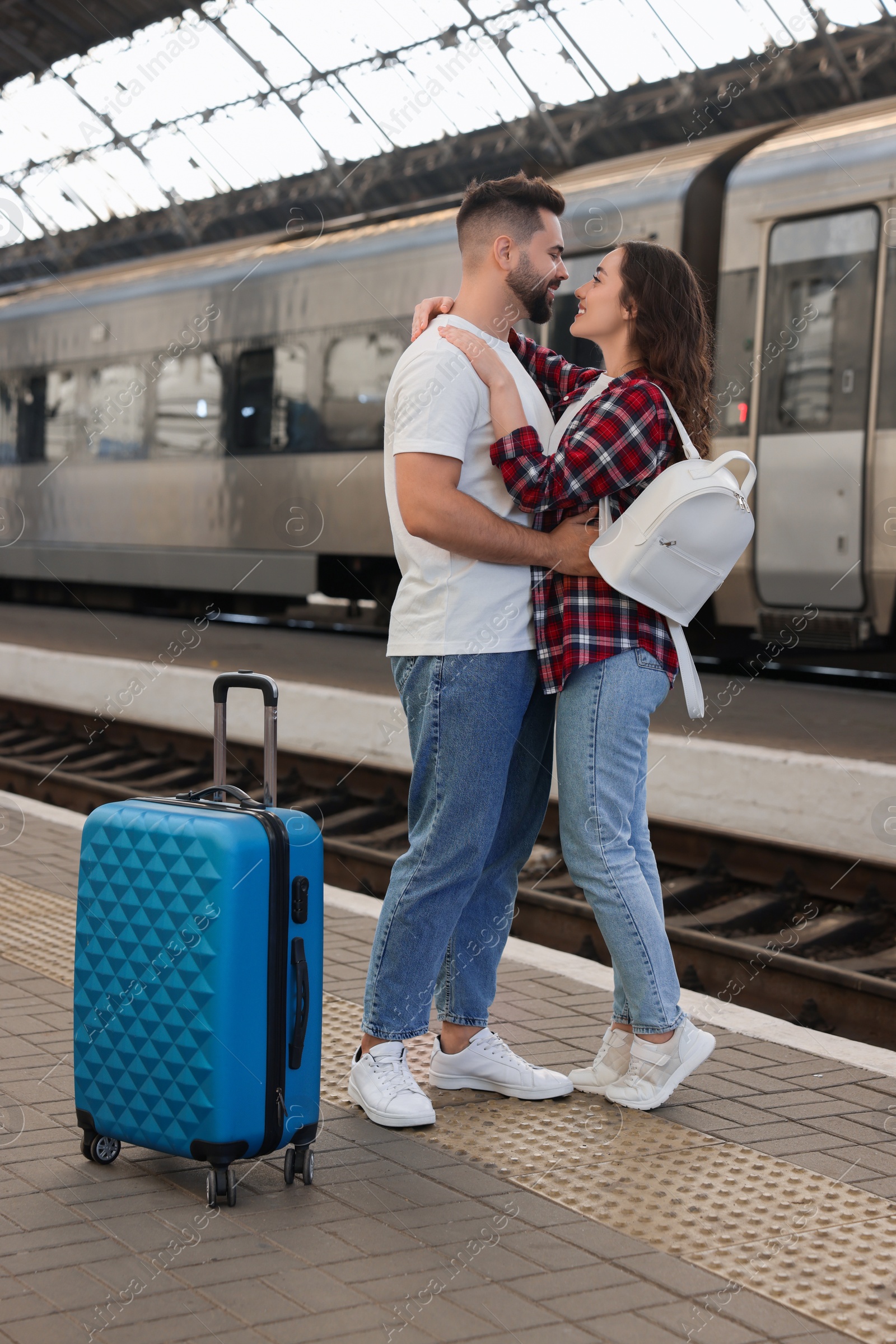 Photo of Long-distance relationship. Beautiful couple on platform of railway station