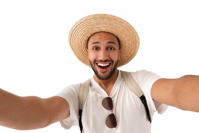 Photo of Smiling young man in straw hat taking selfie on white background