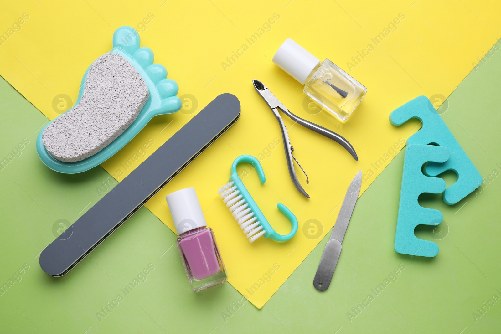 Photo of Set of pedicure tools on color background, flat lay